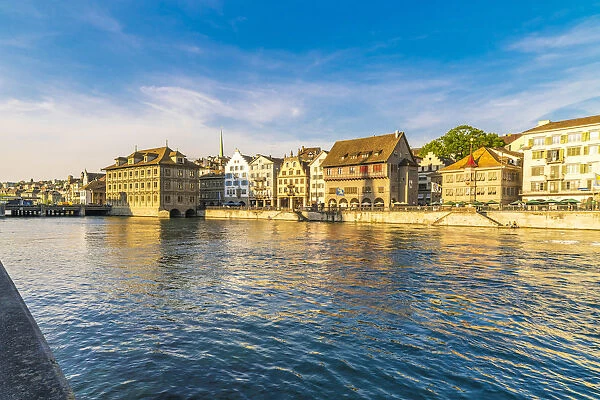 Sunset over the old buildings of Limmatquai, old street along Limmat River, Zurich