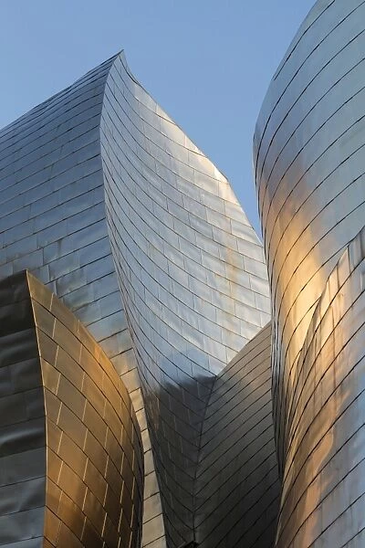 Titanium-clad exterior of the Guggenheim museum at sunset, Bilbao, Biscay, Spain