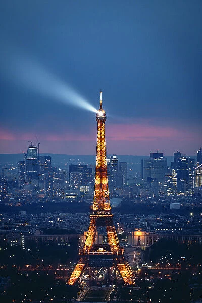 Tour Eiffel and La Defense by night from above, illuminated after sunset. Paris, France