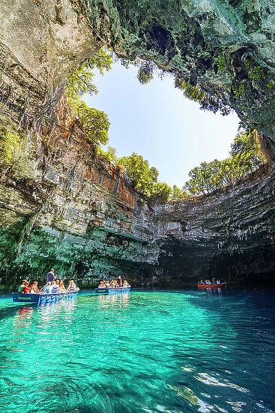 Tourists admiring the cave during a boat trip on the crystal waters of Melissani Lake, Kefalonia, Ionian Islands, Greece