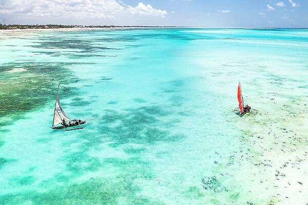 Tourists enjoying a boat trip on traditional dhow in the crystal sea, Paje, Jambiani, Zanzibar, Tanzania