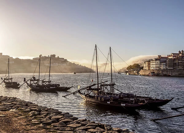 Traditional boats on Vila Nova de Gaia bank of Douro River, Porto Skyline in the
