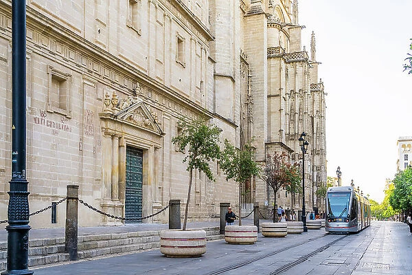 Tram passing outside Seville Cathedral, Seville, Andalusia, Spain