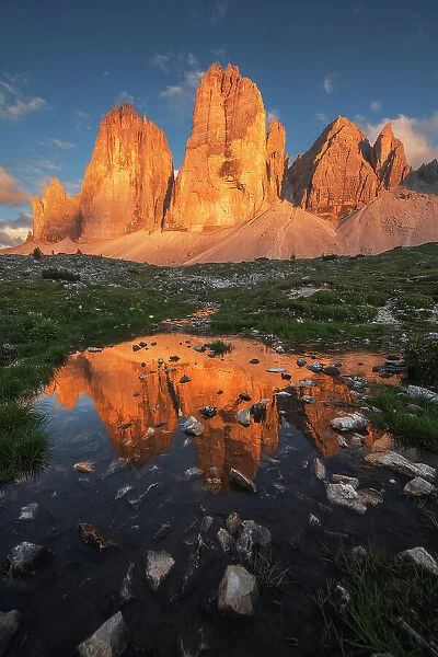 Tre Cime di Lavaredo reflecting in a small pond created by the rain of the previous days. Dolomites, Italy