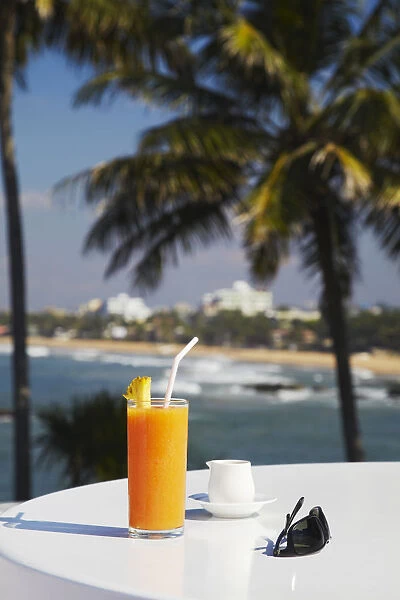 Tropical fruit juice on outdoor terrace table at Mount Lavinia Hotel, Mount Lavinia