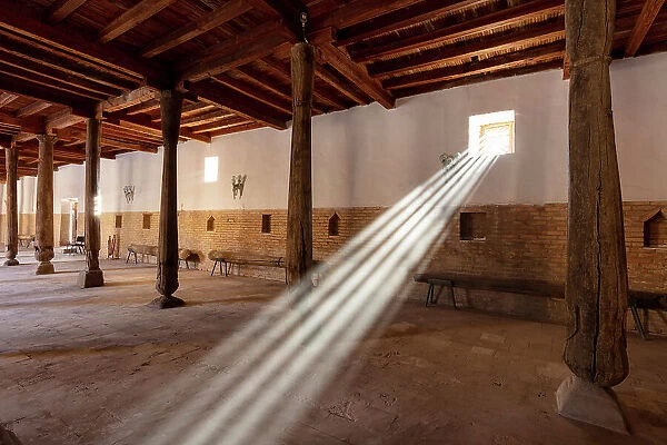 Uzbekistan, Khiva, Juma mosque, sun rays shine through a window in the Friday mosque where the ceiling is supported by 215 wooden pillars, sun rays