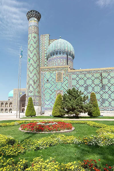 Uzbekistan, Samarkand, Registan square garden and minaret
