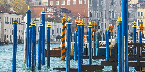 Venice, Veneto, Italy. Painted gondola mooring poles on the Grand Canal