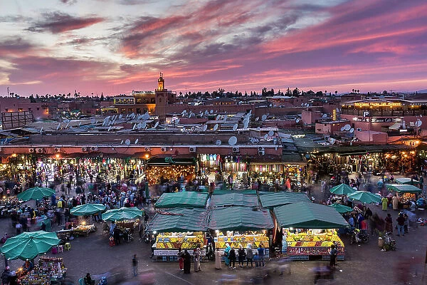 View over Djemaa el-Fna square and market place toward Koutoubia Mosque at dusk, Marrakesh, Morocco