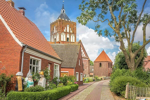 Village street and Kreuzkirche Pilsum, Krummhoern, East Frisia, Lower Saxony, Germany