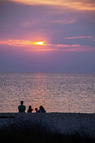 Visitors gather at Sunset Beach to watch the sunset