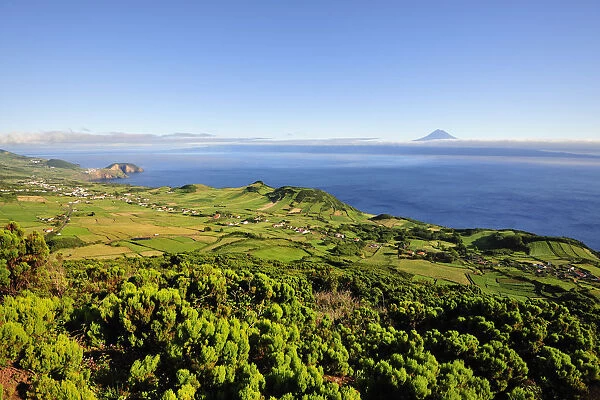 Volcanic craters along the Sao Jorge island and the Pico volcano on the horizon