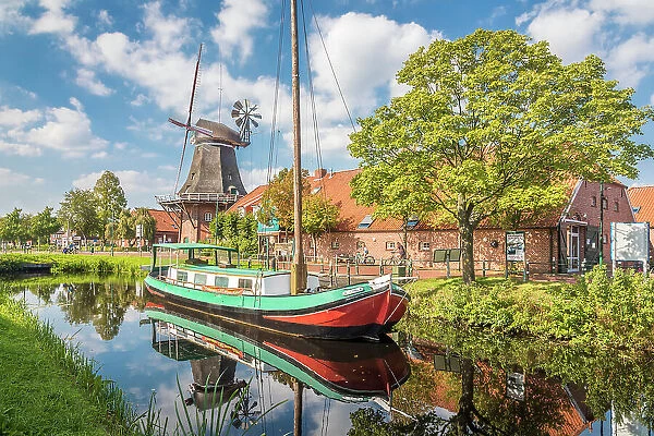 Windmill OstGrossefehn and peat ship on the Fehn Canal, Grossefehn, East Frisia, Lower Saxony, Germany
