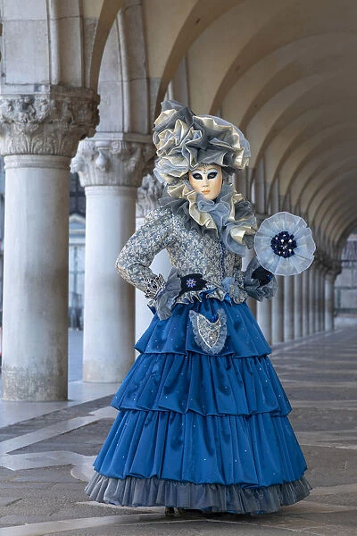 A woman poses under the colonnades in St. Marks Square during the Venice Carnival