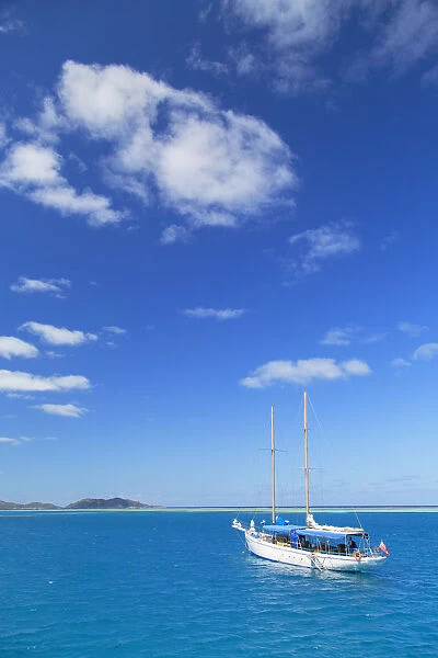 Yacht in lagoon with Malolo Island, Mamanuca Islands, Fiji
