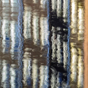 Abstract details of buildings reflected in a typical canal of the river Amstel Amsterdam