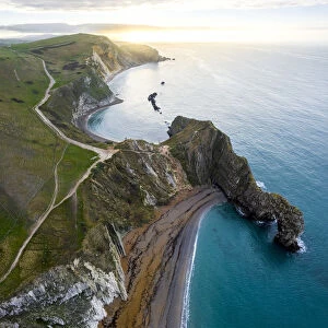 Aerial view at sunrise of the Durdle Door, a natural limestone arch on the Jurassic Coast