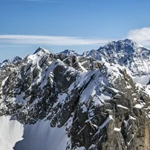 Aerial view of Torrone Peak in winter with Bernina Peak in the background. Valmasino