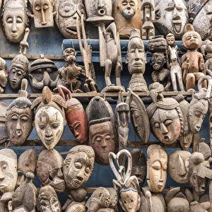 Africa, Senegal, Dakar. Artisanal wooden masks outside the food market