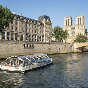 Boat tour along the banks of the Seine with cathedral Notre Dame in the background