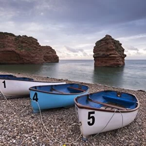 Boats pulled up on the shingle at Ladram Bay on the Jurassic Coast, Devon, England
