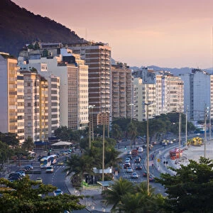 Brazil, Rio De Janeiro, Copacabana, Traffic along Avenue Atlantica at dawn