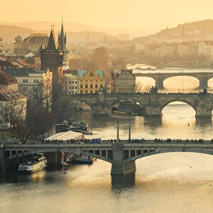 Bridges over Vltava river in city at sunset, Prague, Bohemia, Czech Republic