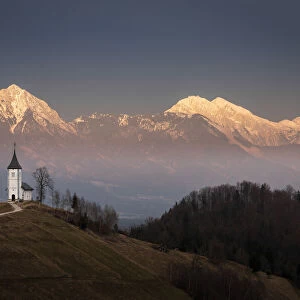 Church of St. Primoz and Storzic Mountain at sunset, Jamnik, Slovenia