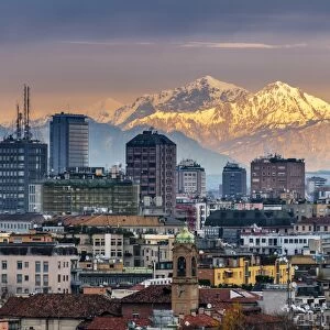 City skyline at sunset with the snowy Alps in the background, Milan, Lombardy, Italy