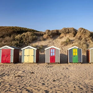 Colourful beach huts on Saunton Sands beach, Devon, England