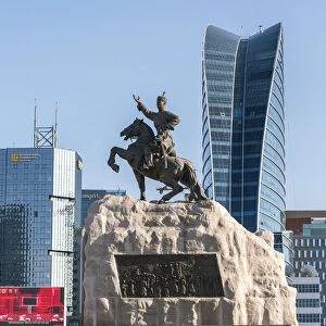 Damdin Sukhbaatar statue with skyscrapers in the background. Ulan Bator, Mongolia