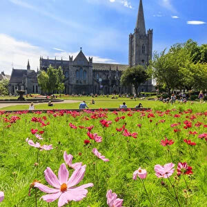 Europe, Dublin, Ireland, people sitting on the gardens at St. Patrick Cathedral