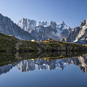 The group of Mont Blanc is reflected in Lake Cheserys. Chamonix. Haute Savoie. France