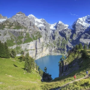 Hikers around Lake Oeschinensee Bernese Oberland Kandersteg Canton of Bern Switzerland