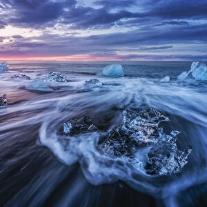 Icebergs being washed ashore on Breidamerkursandur black sands