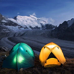 Illuminated tents by nigh camping close to the Grand Combin glacier, Grand Combin
