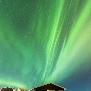 Laugarvatn, Iceland. Northern lights over typical Icelandic houses in winter