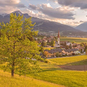 A lonely tree in the hills surrounding the little village of Vill at sunset, Innsbruck