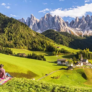 Man enjoying the view over St. Magdalena in Autumn, Val di Funes, Dolomites, South Tyrol