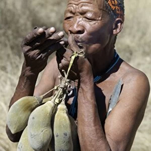 A N!!S hunter-gatherer lights his pipe to relax having