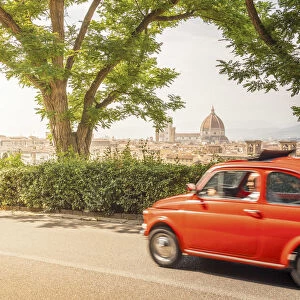 Original old red Fiat Cinquecento (500) with Florence Cathedral in background, Tuscany