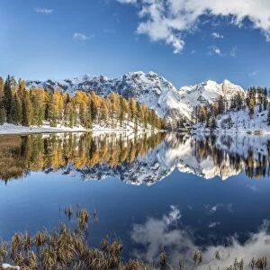 Panoramic shot of the Lake Malghette in autumn with Dolomites of Brenta in the background