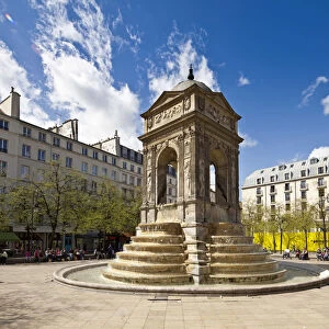 Paris, France. The sun shines on the Fountain des Innocents in the Place Joachim du