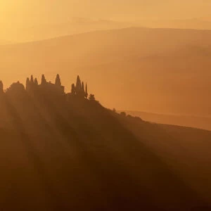 Podere Belvedere surrounded by haze during autumn at sunrise, Val d Orcia, Tuscany