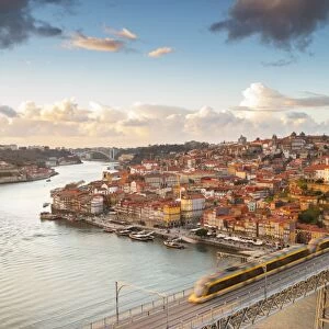 Porto at sunset with a train on Louis I ∞ bridge on Douro River. Oporto city, Porto district, Portugal, Europe