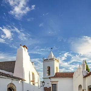 Portugal, Alentejo, Monsaraz. Cobbled streets leading to the bell tower gateway of the