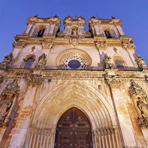 Portugal, Estremadura, Alcobaca, Facade of Santa Maria de Alcobaca Monastery at dusk