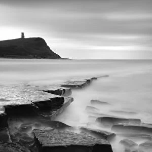 Rocks in Kimmeridge Bay with Clavell Tower in the background, Dorset, UK