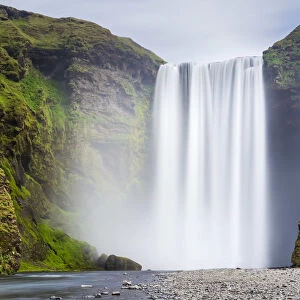 Scenic view of Skogafoss waterfall on cliff, South Iceland, Iceland