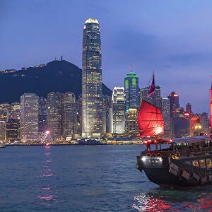 Skyline of Hong Kong Island and junk boats at dusk, Hong Kong
